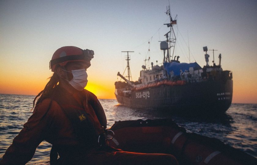 Fotografie rozdávaná německou nevládní organizací Sea Eye, ukazuje jejího člena na gumové lodi během operace na záchranu lidí z malých lodí u libyjského pobřeží, které pak umístí na loď Alan Kurdi (6. dubna 2020). Foto: AFP PHOTO / SEA-EYE.ORG / Cedric FETTOUCHE / Profimedia.